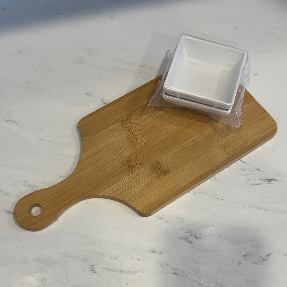 Wooden charcuterie board with 2 white melamine dishes